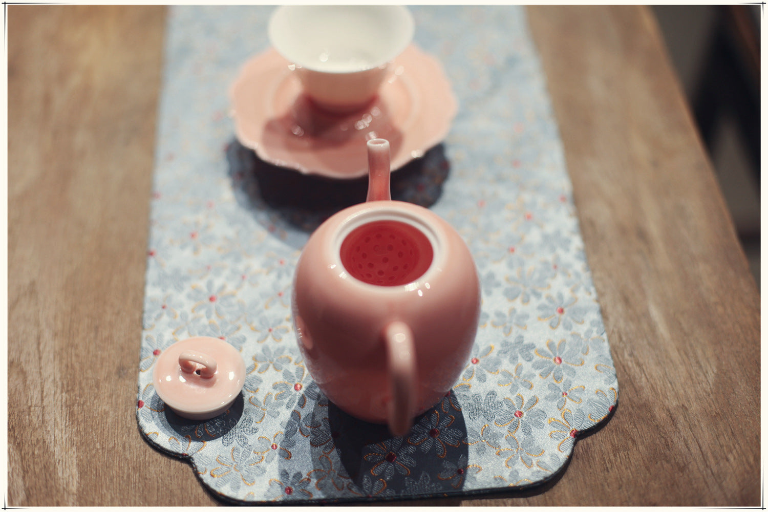 this is a pink ceramic teapot