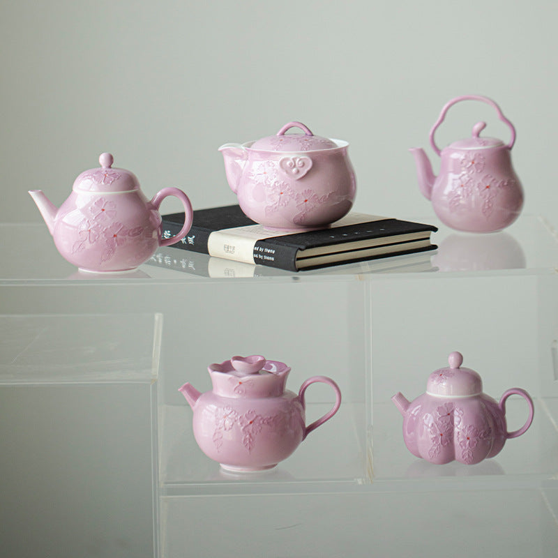 This is a Arita ware teapot. this is a pink ceramic teapot