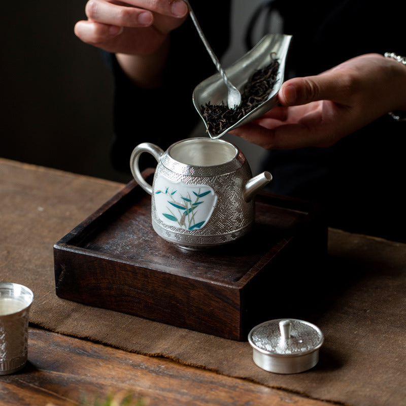 This is a gilted silver ceramic teapot