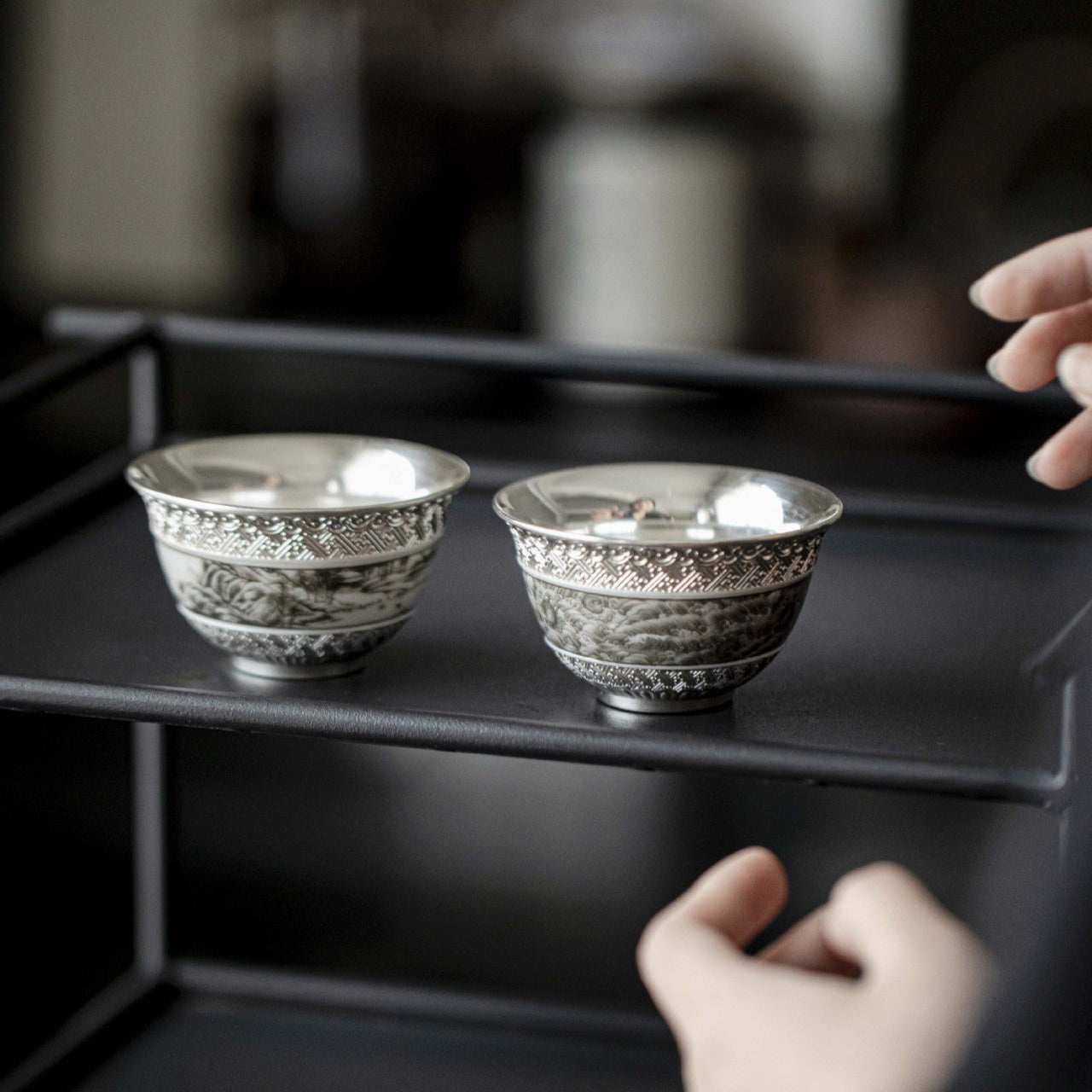 This is a gilted silver ceramic teacup