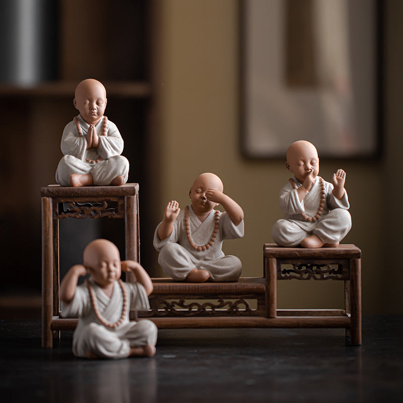 this is a mini pottery monk sculpture