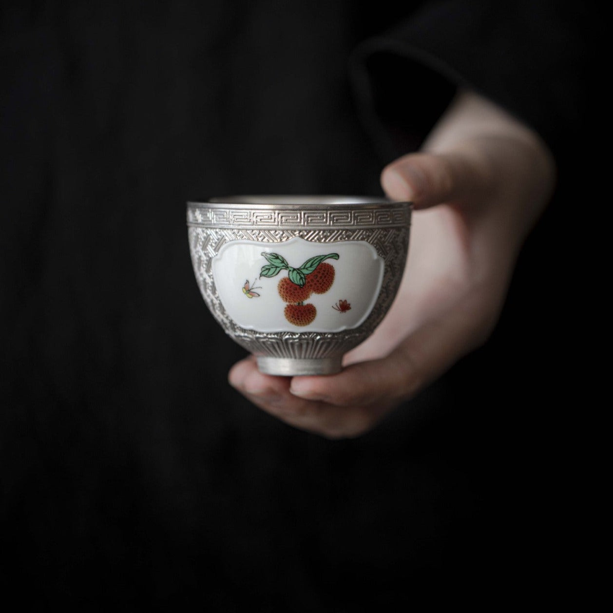 This is a gilted silver ceramic teacup