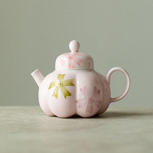 this is a pink ceramic teapot