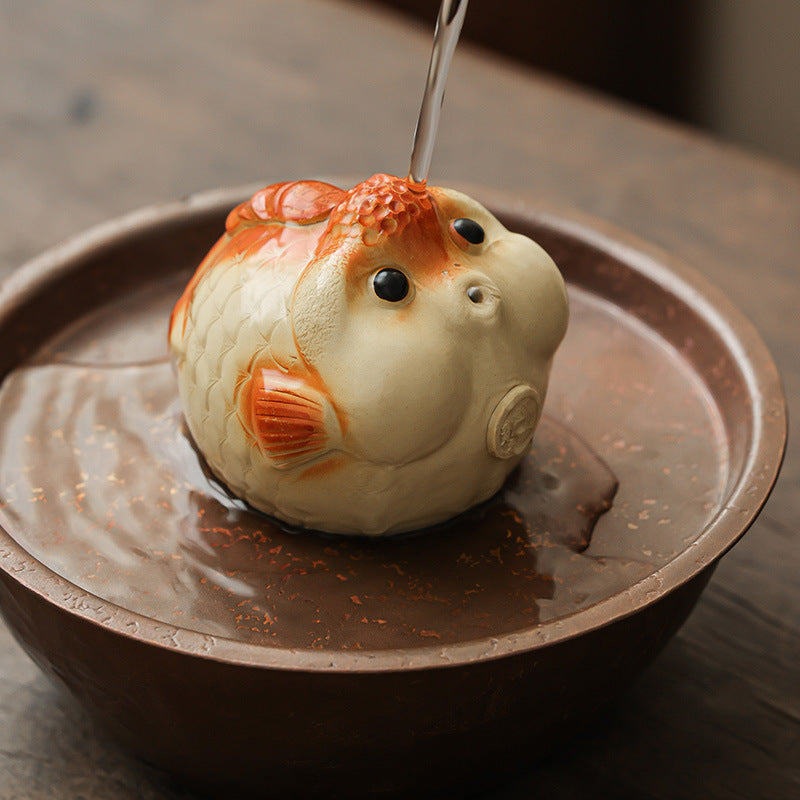 This is a Yixing purple clay bubble fish teapet