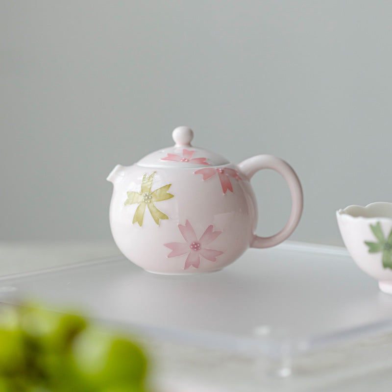 this is a pink ceramic teapot