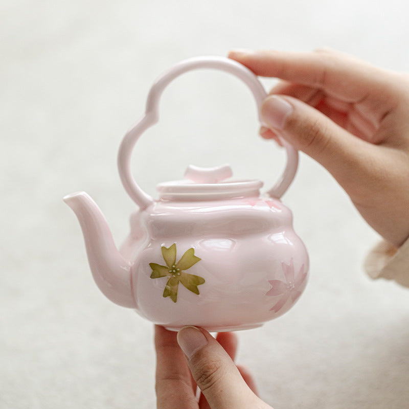 this is a pink ceramic teapot