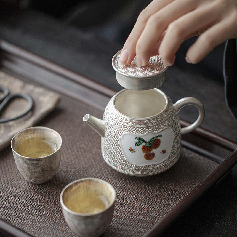 This is a gilted silver ceramic teapot