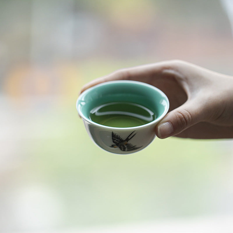 this is a ceramic teapot. this is a green gaiwan