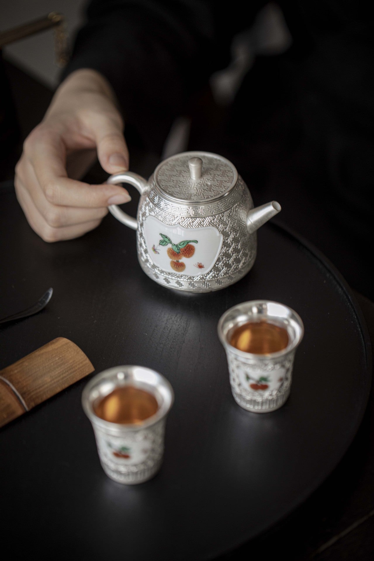 This is a gilted silver ceramic teapot