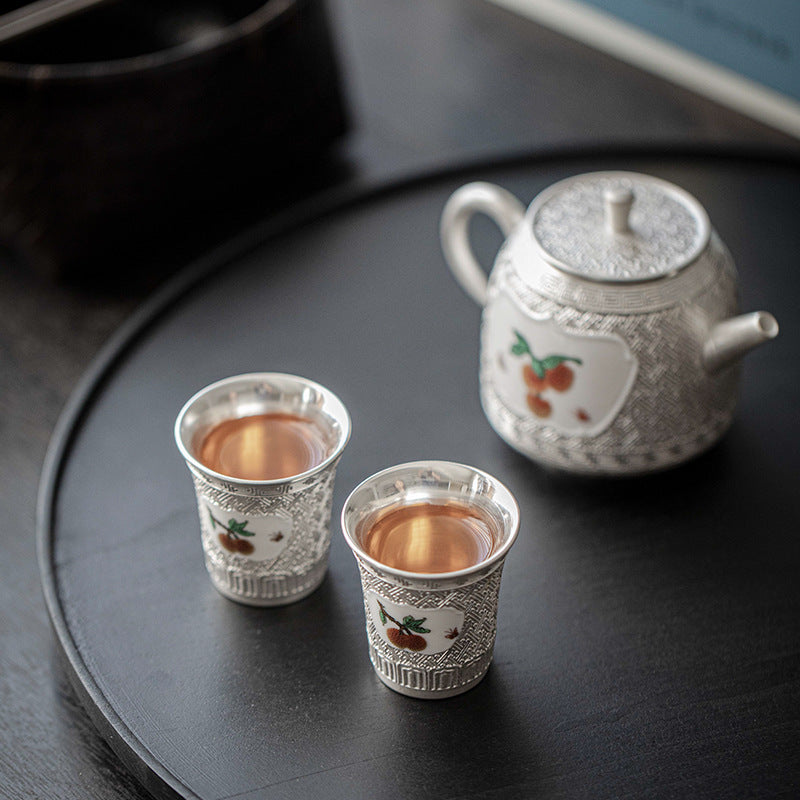 This is a gilted silver ceramic teapot