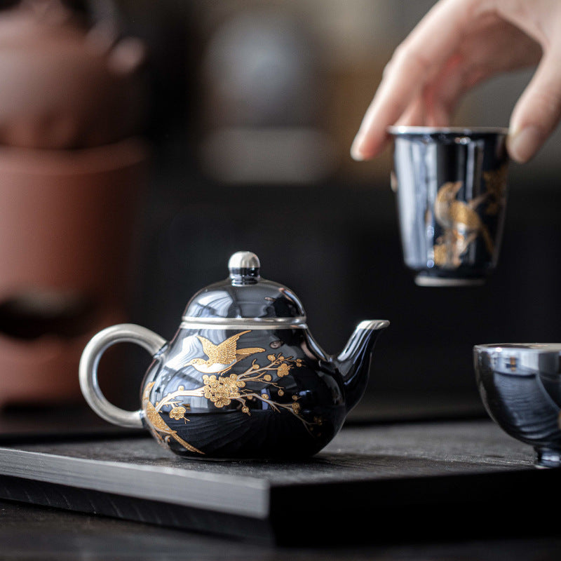 this is a ceramic teapot. this is a gilded silver teapot