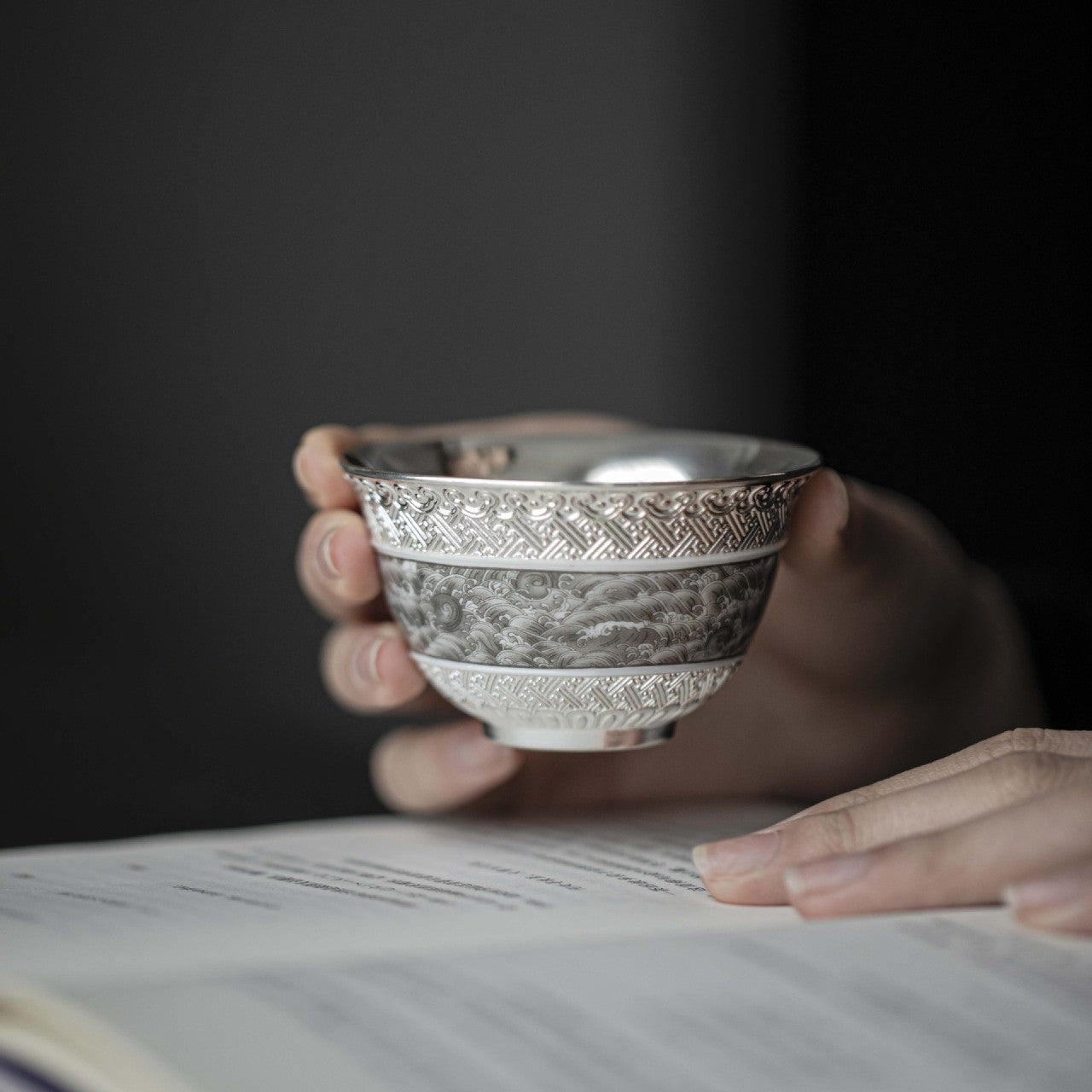 This is a gilted silver ceramic teacup