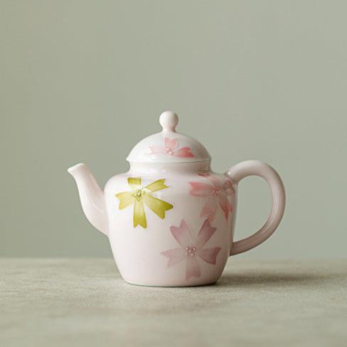 this is a pink ceramic teapot