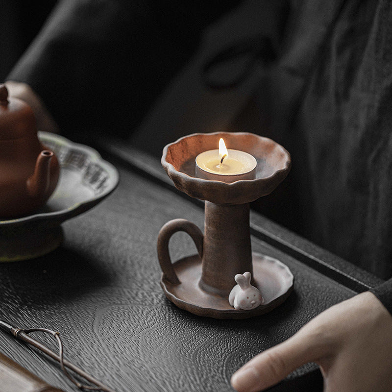 This is a pottery candlestick candle holder