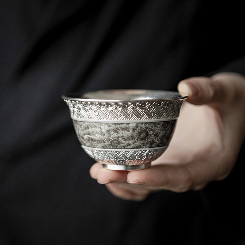 This is a gilted silver ceramic teacup