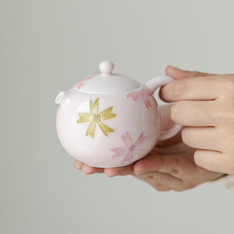 this is a pink ceramic teapot