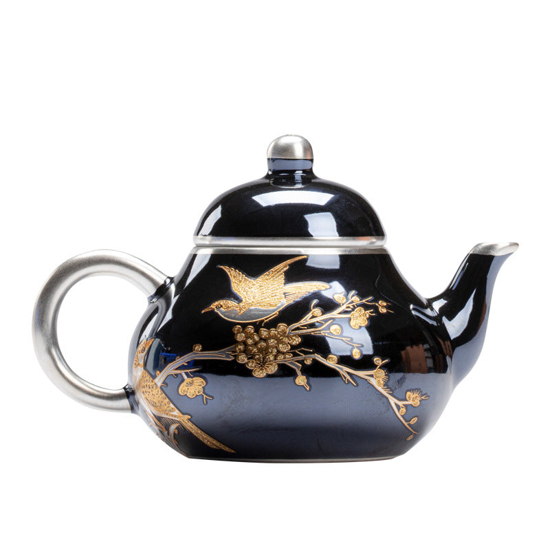 this is a ceramic teapot. this is a gilded silver teapot