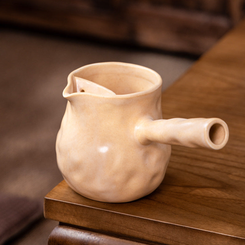 This is a pottery side handle kettle