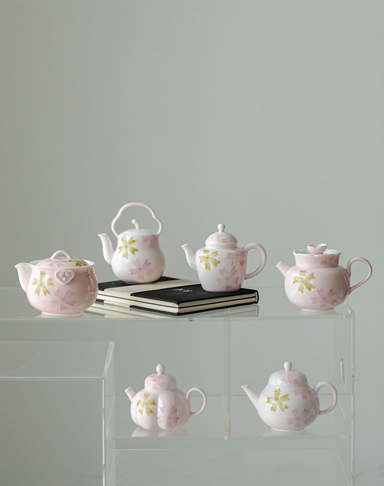 this is a pink ceramic teapot