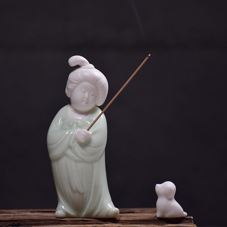 This is a white porcelain teapet incense holder