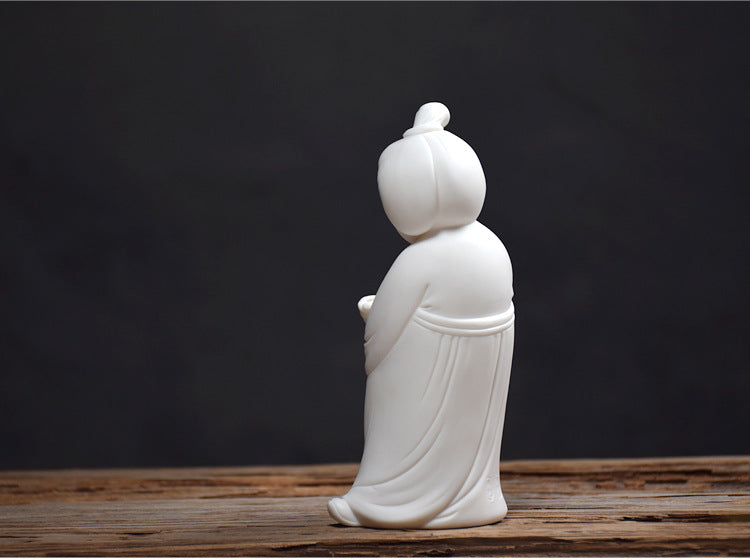 This is a white porcelain teapet incense holder