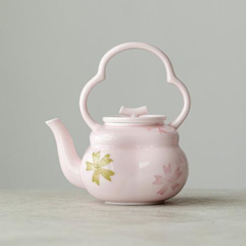 this is a pink ceramic teapot