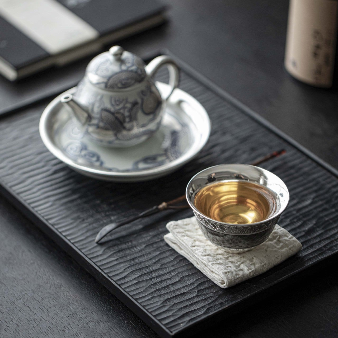 This is a gilted silver ceramic teacup