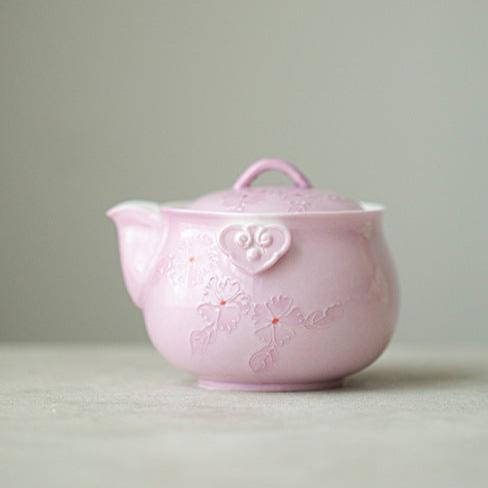 This is a Arita ware teapot. this is a pink ceramic teapot