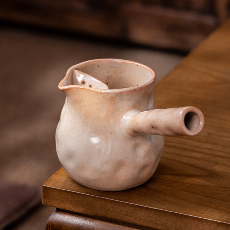 This is a pottery side handle kettle