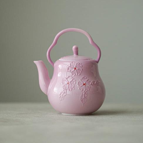 This is a Arita ware teapot. this is a pink ceramic teapot