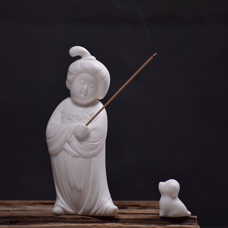 This is a white porcelain teapet incense holder