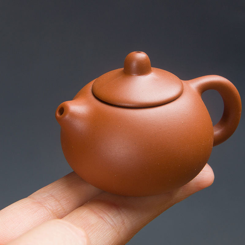 this is a mini zhuni red clay teapot