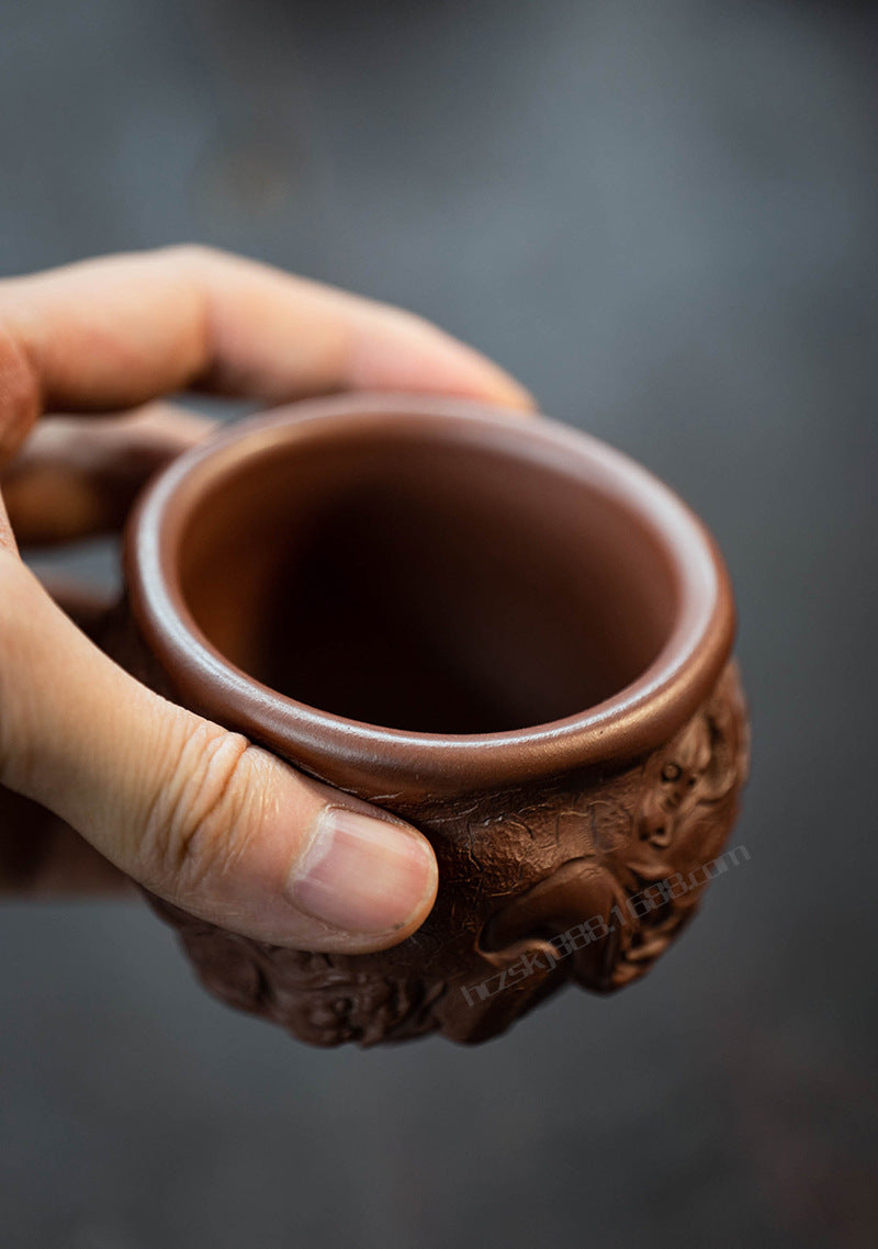 This is a purple clay dragon teacup