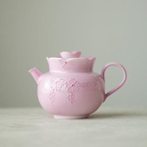 This is a Arita ware teapot. this is a pink ceramic teapot