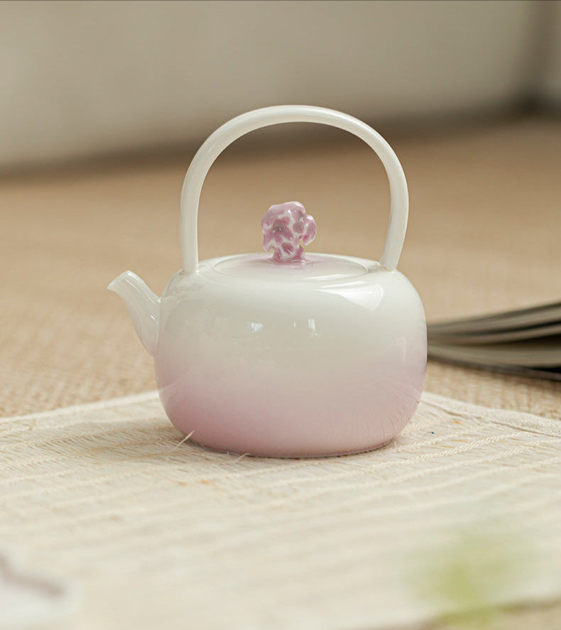 this is a purple ceramic teapot