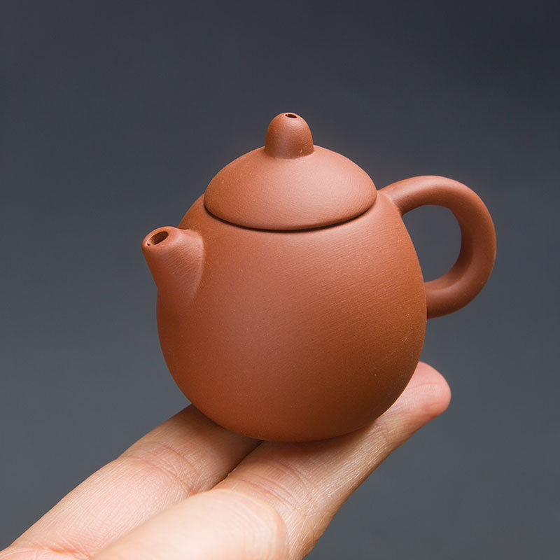 this is a mini zhuni red clay teapot