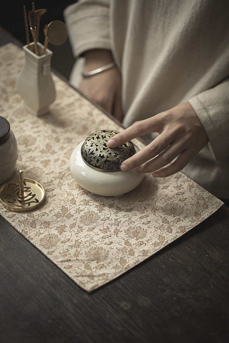 This is a silk brocade tea mat.this is a waterproof table cloth