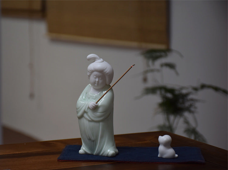 This is a white porcelain teapet incense holder