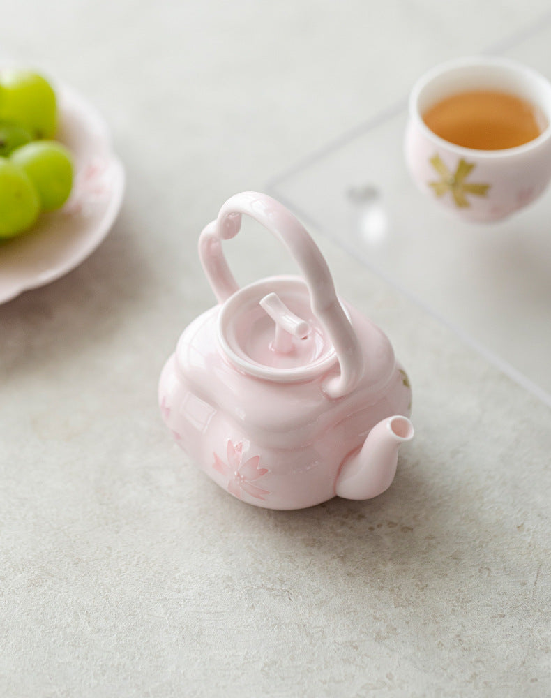 this is a pink ceramic teapot