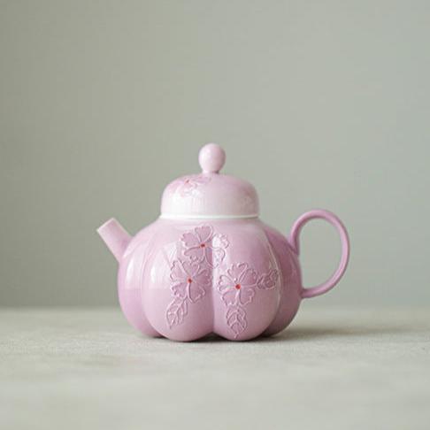 This is a Arita ware teapot. this is a pink ceramic teapot