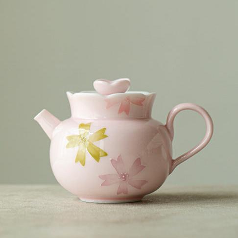 this is a pink ceramic teapot