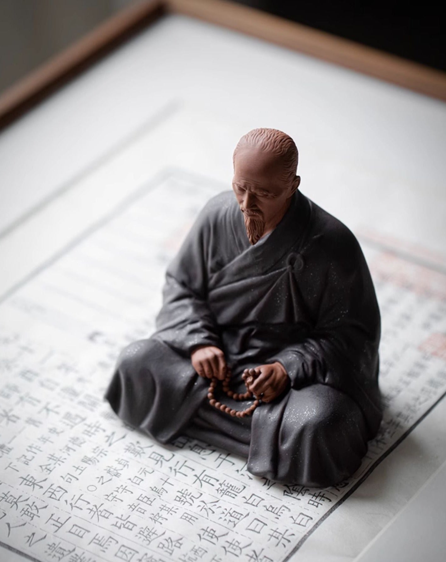 this is a mini pottery monk sculpture