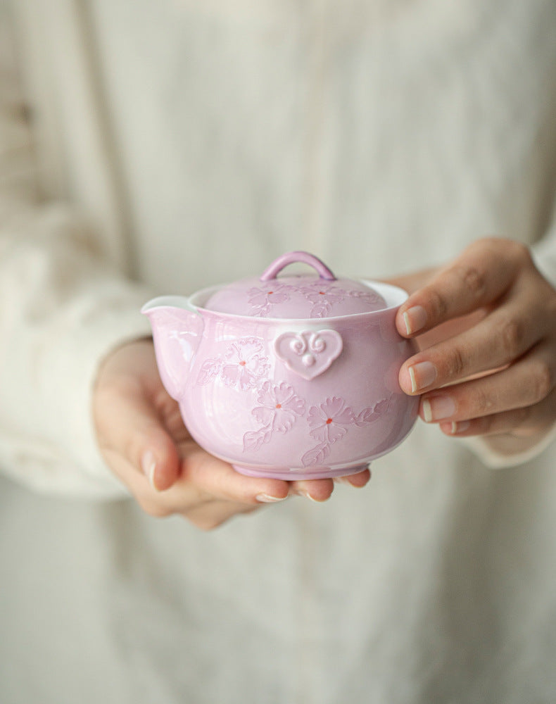 This is a Arita ware teapot. this is a pink ceramic teapot