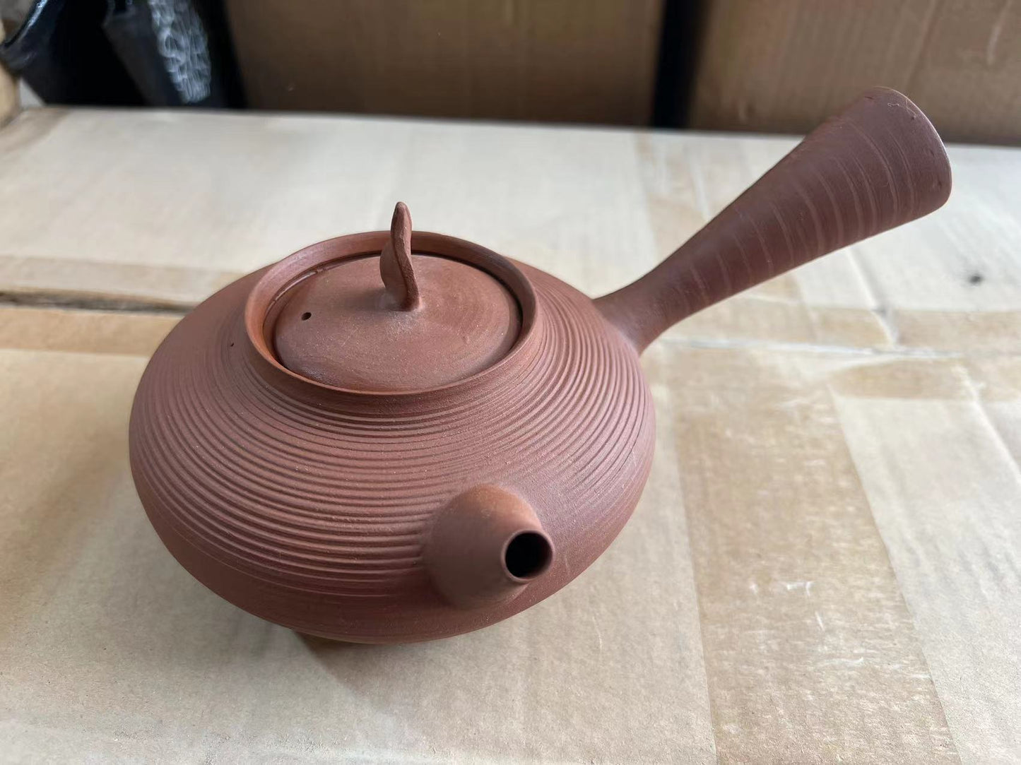 This is a pottery side handle kettle