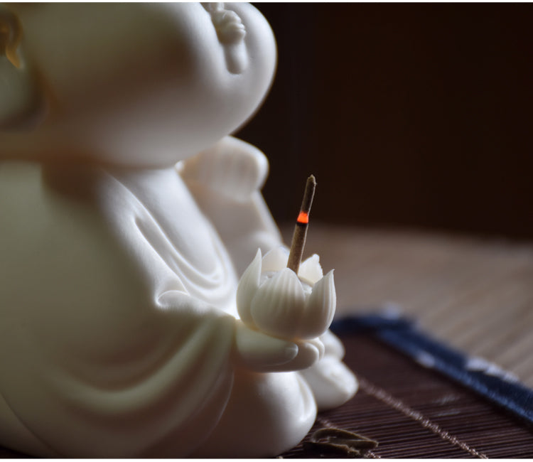 This is a white porcelain buddha teapet incense holder