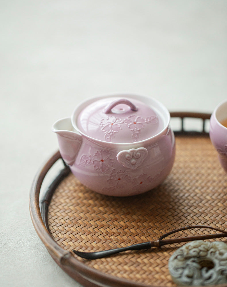 This is a Arita ware teapot. this is a pink ceramic teapot