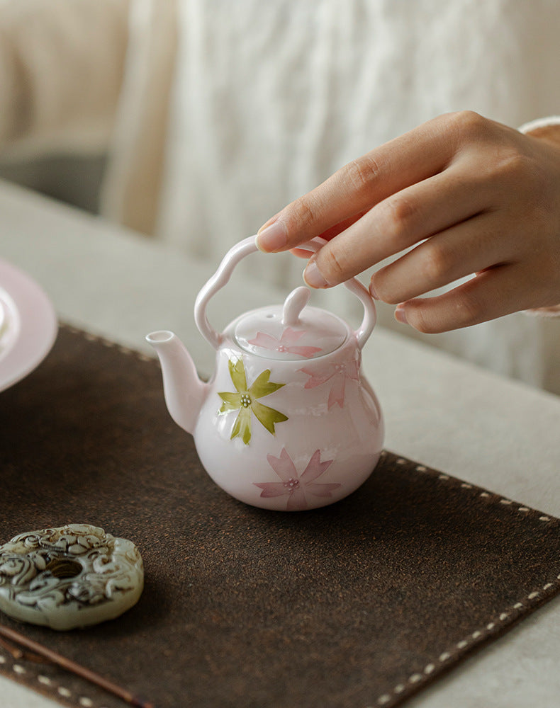 this is a pink ceramic teapot