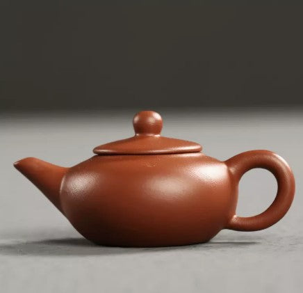 this is a mini zhuni red clay teapot