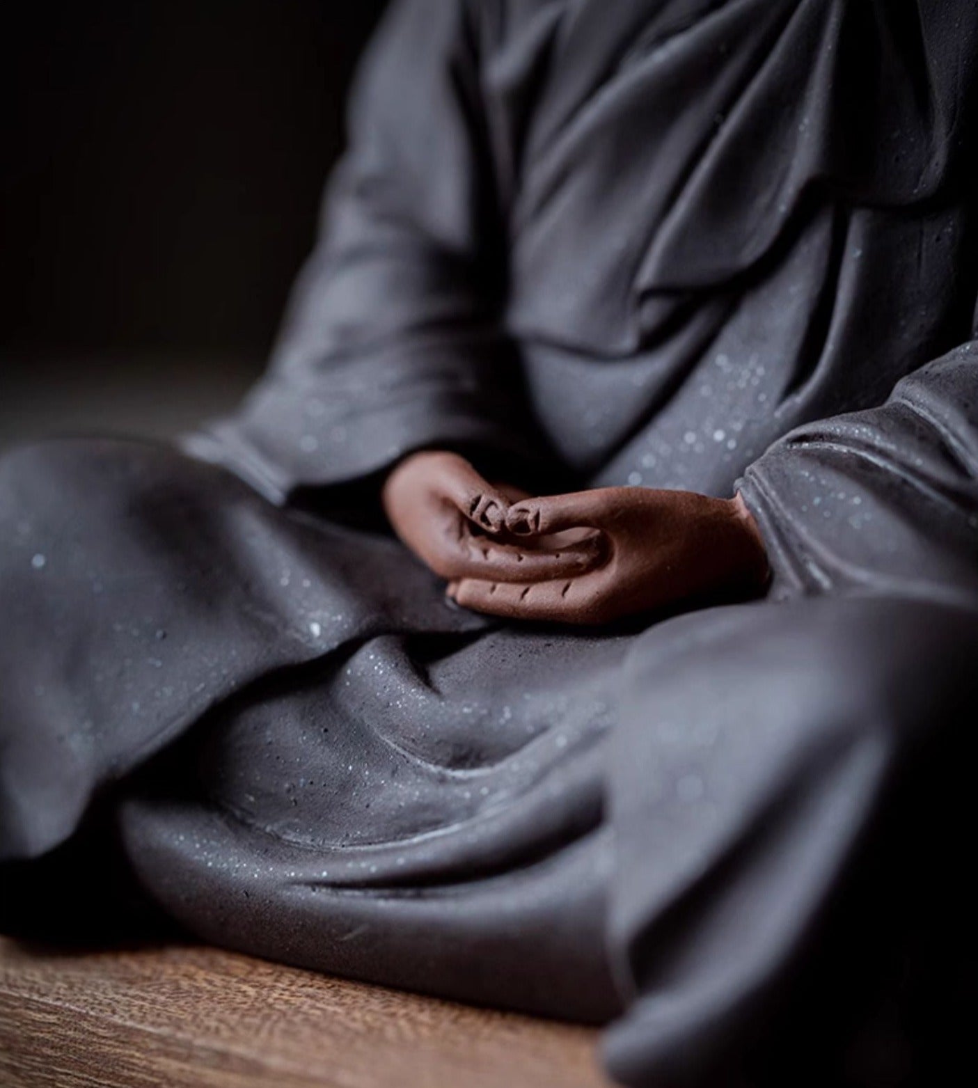 this is a mini pottery monk sculpture