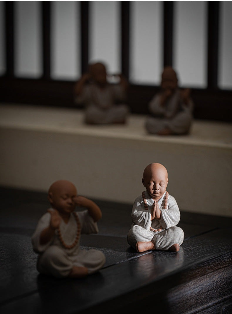 this is a mini pottery monk sculpture